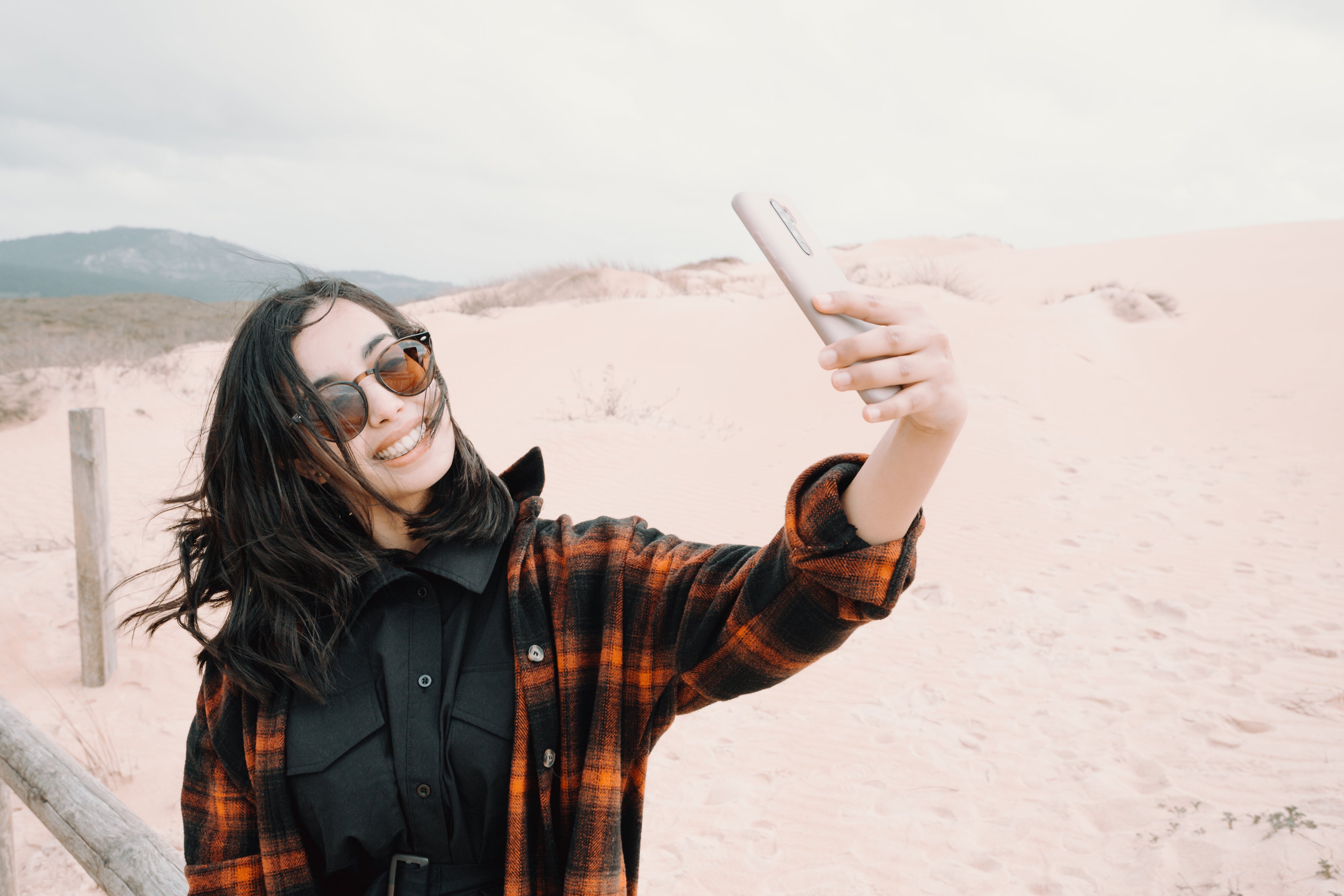 files/woman-in-sunglasses-takes-a-selfie-at-the-beach.jpg